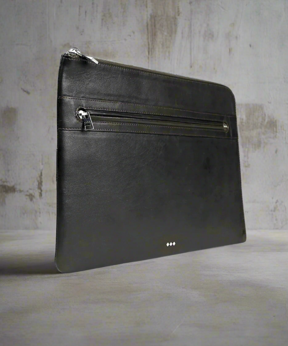 Black leather pouch with zipper on a gray background