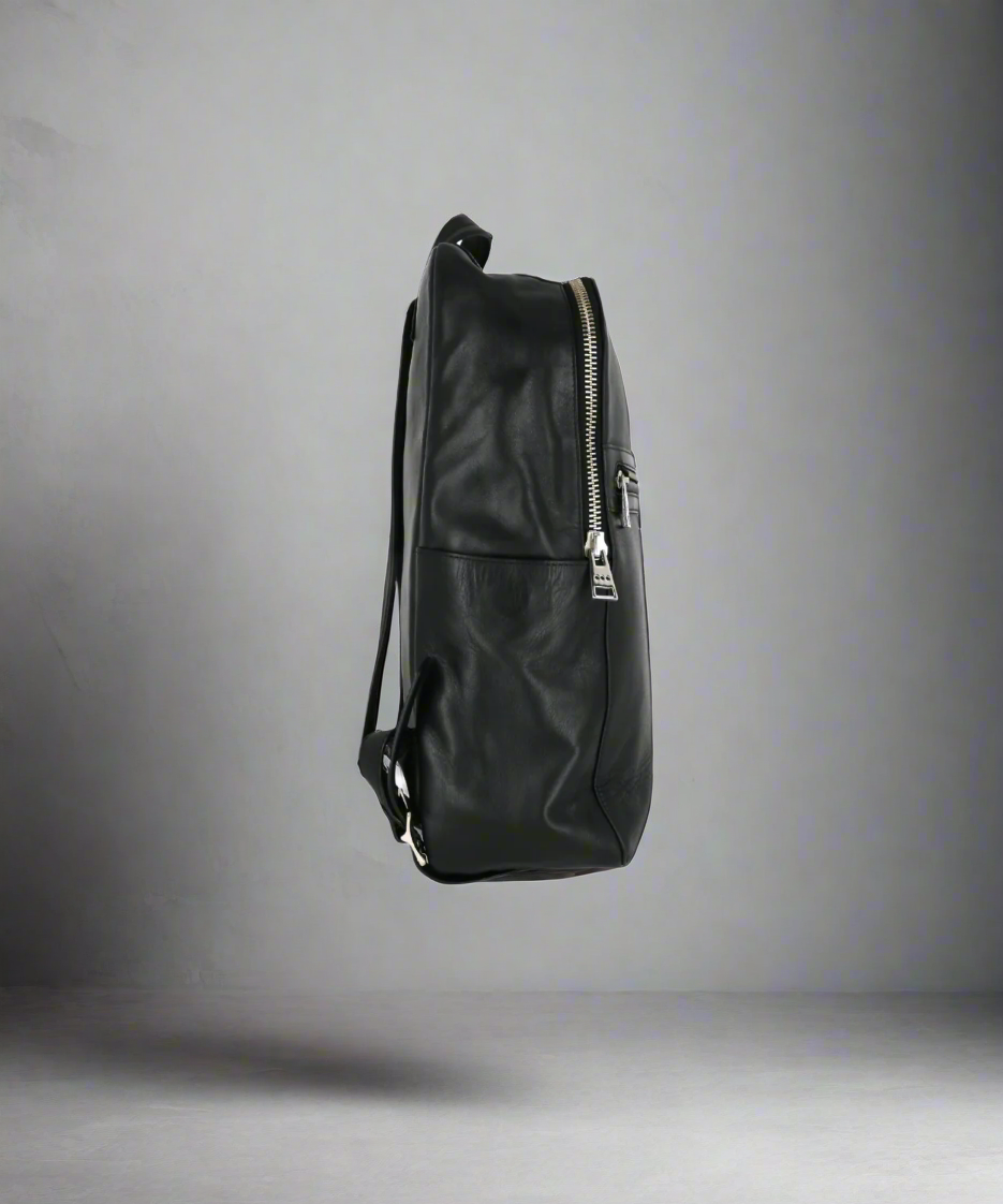 Black leather backpack on a gray background