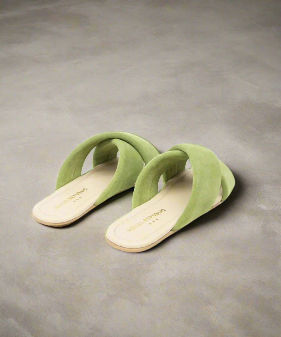 Pair of green sandals on a grey background