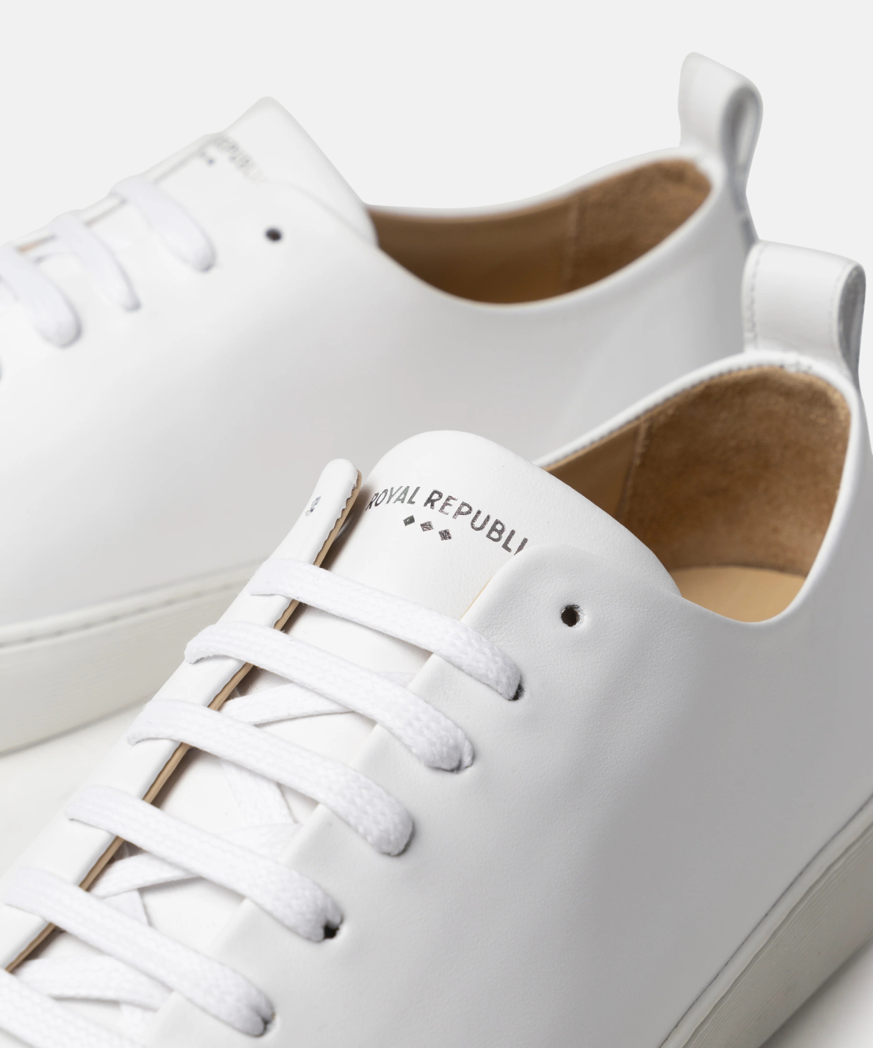 White sneakers with brand name on a light background