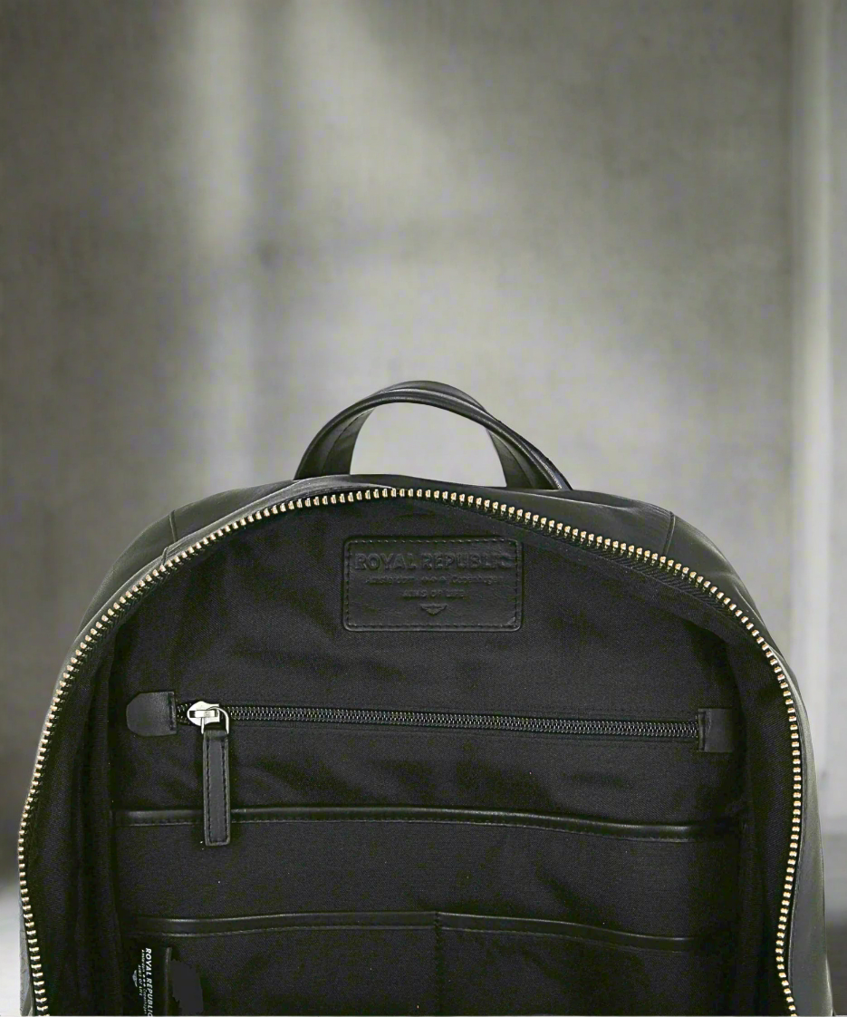 Black backpack with visible brand logo on a gray background