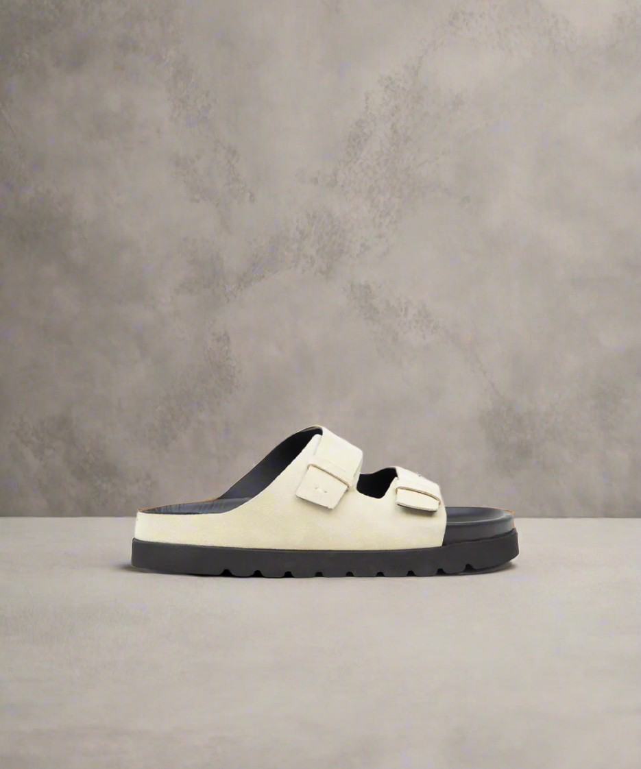 A beige and black men's sandal with two straps and a buckle closure, featuring a lightweight design with a EVA outsole.