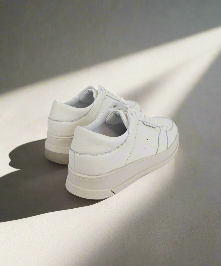 White Royal RepubliQ sneakers on a light gray background