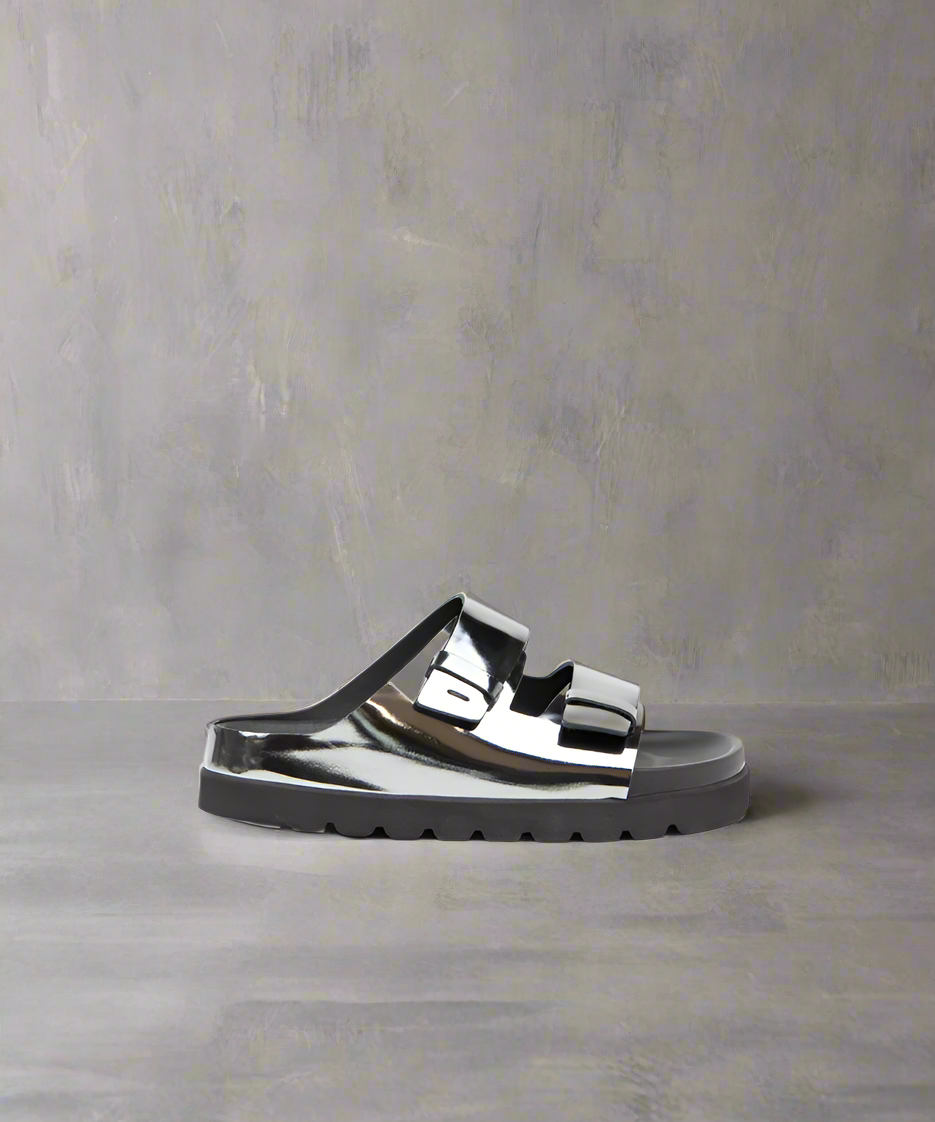 A shiny gun metal sandal with a metallic leather upper and a thick, chunky sole.