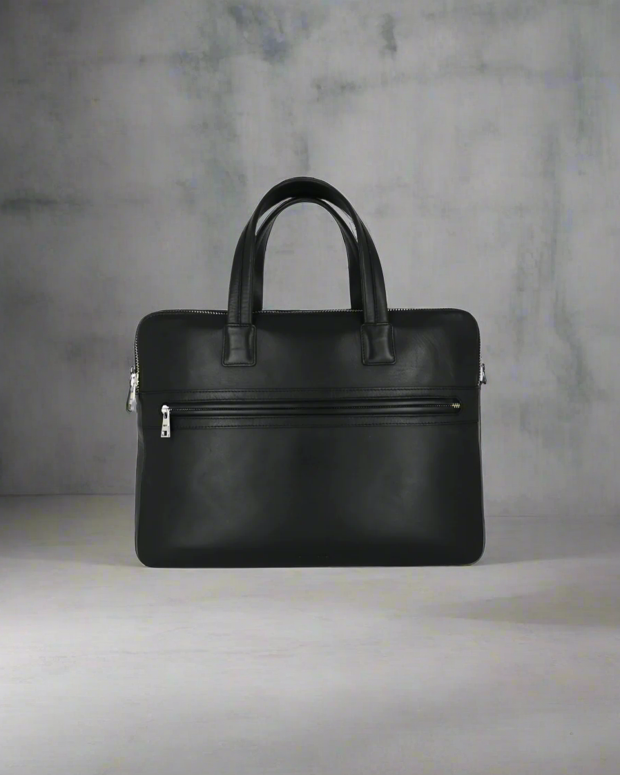 Black Royal RepubliQ leather briefcase on a gray background