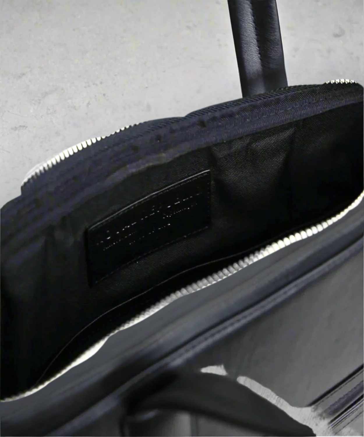 Close-up of a black Royal RrepubliQ laptop on a light gray background