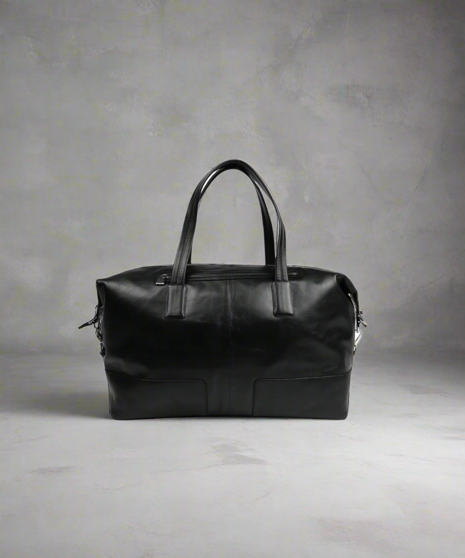 Black Royal RepubliQ leather duffel bag on a gray background