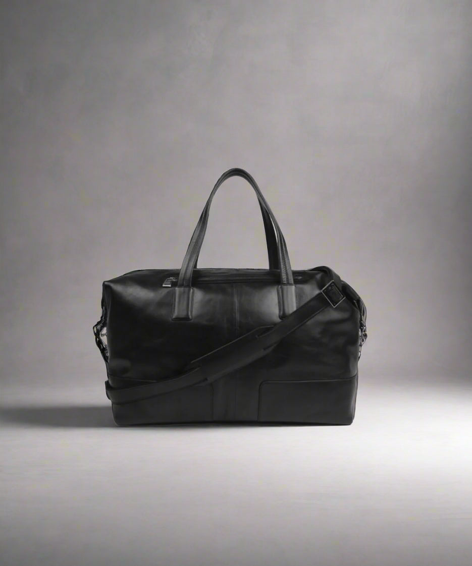 Black Royal RepubliQ leather duffel bag on a gray background