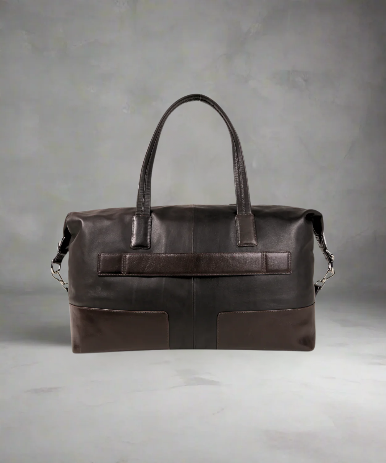 Brown Royal RepubliQ leather duffel bag on a gray background