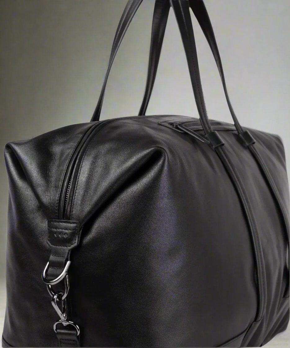 Black Royal RepubliQ leather duffel bag with handles on a gray background