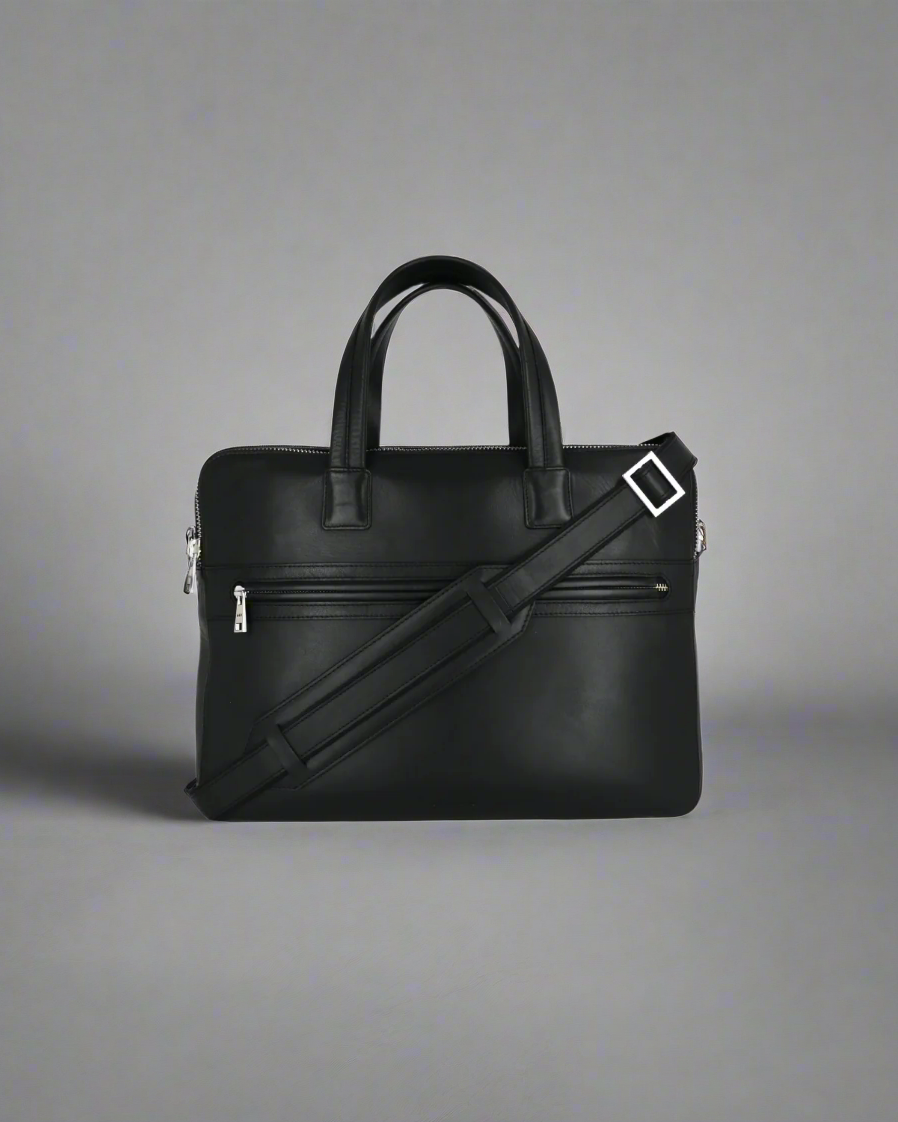 Black Royal RepubliQ leather briefcase with shoulder strap on a gray background