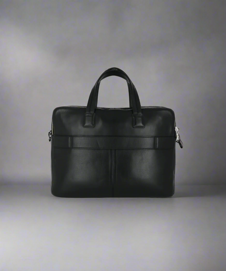 Black Royal RepubliQ leather briefcase on a gray background