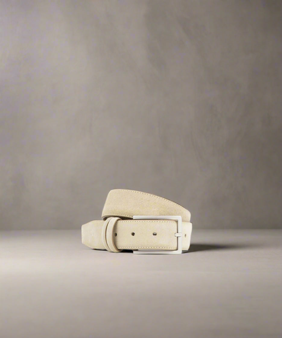 Beige Royal RepubliQ leather belt with a matt silver metal buckle on a gray background