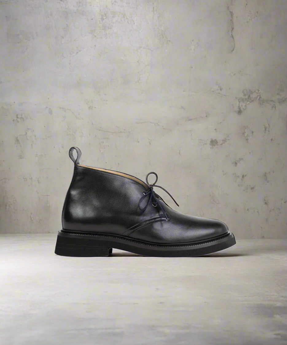 Black Royal RepubliQ leather chukka on a textured gray background