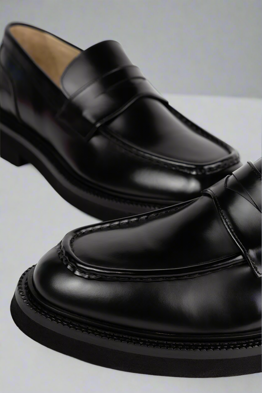 Black Royal RepubliQ Leather loafers on a light gray background