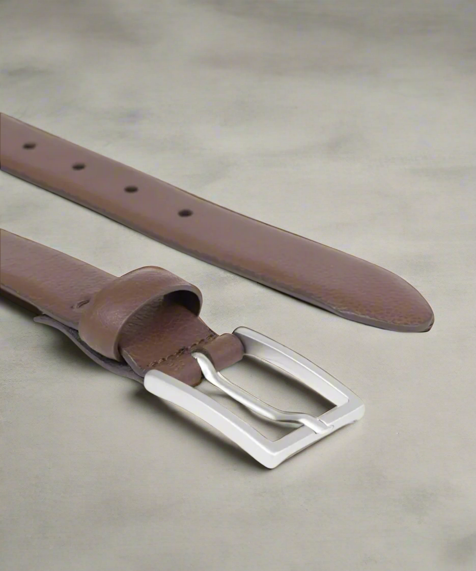 Brown Royal RepubliQ leather belt with matt silver buckle on a beige background