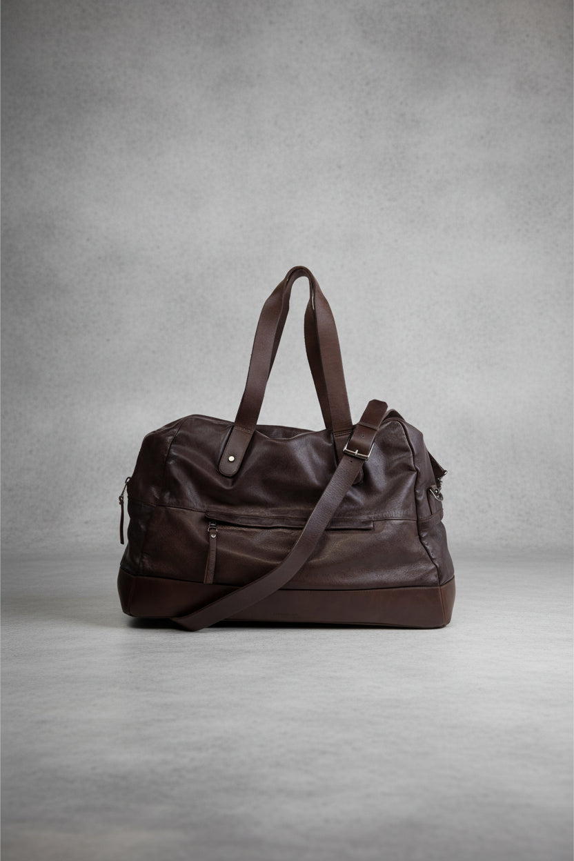 Brown Royal RepubliQ washed leather duffel bag on a light gray background
