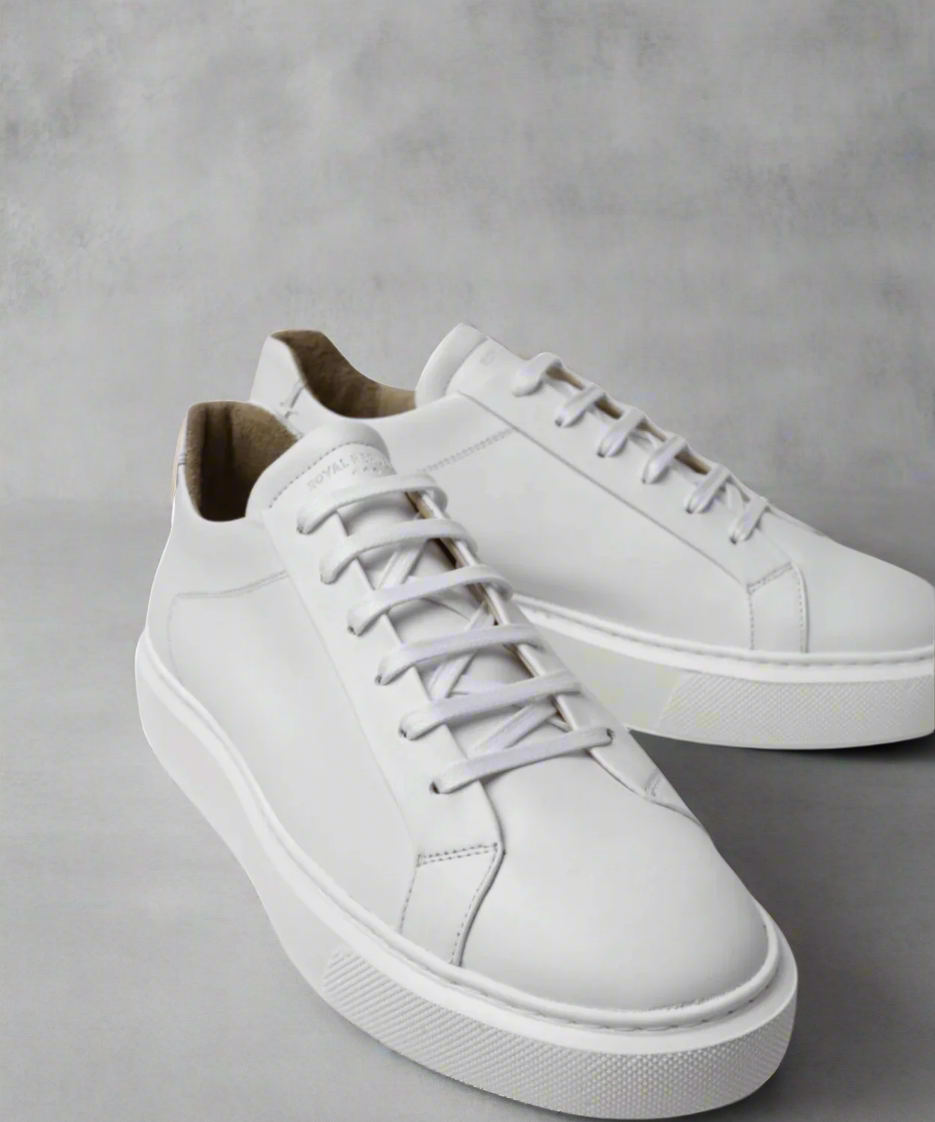 White Royal RepubliQ leather sneakers on a gray background