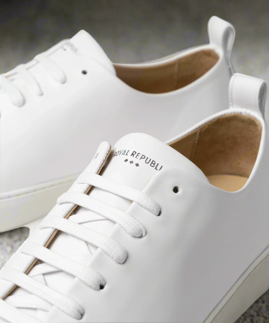 White sneakers with brand name on a light background