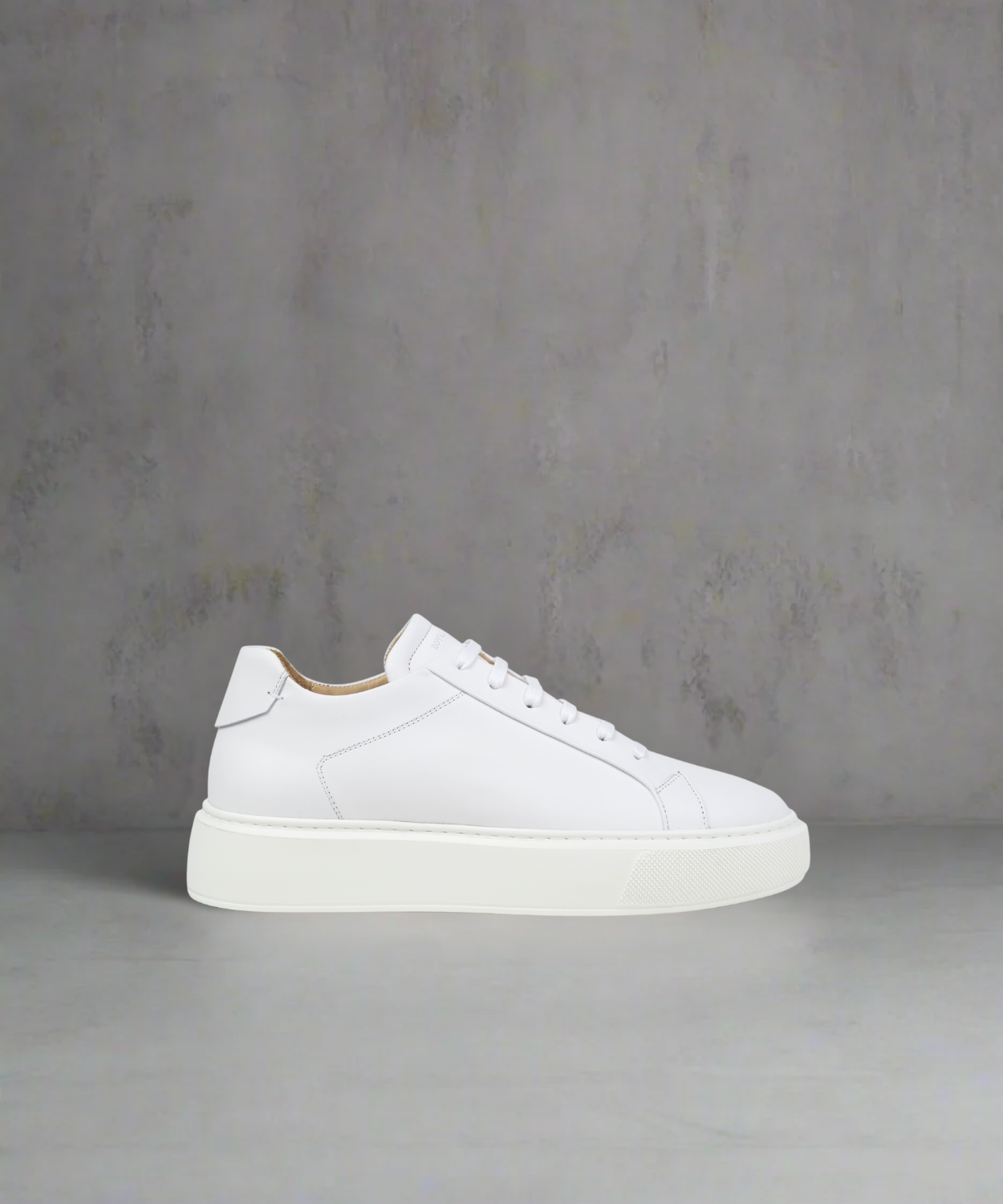 White Royal RepubliQ leather sneaker on a gray background