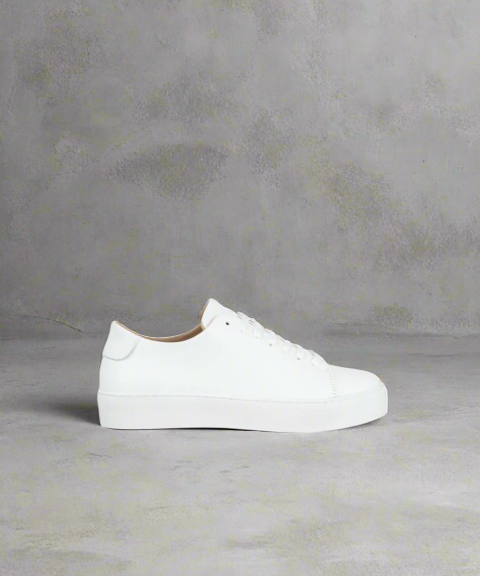 White Royal RepubliQ sneaker on a gray background