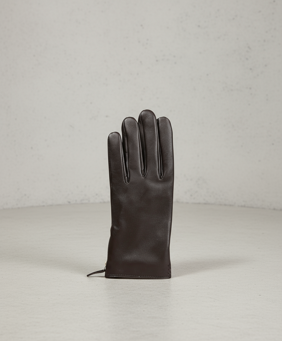 Brown leather glove on a gray background