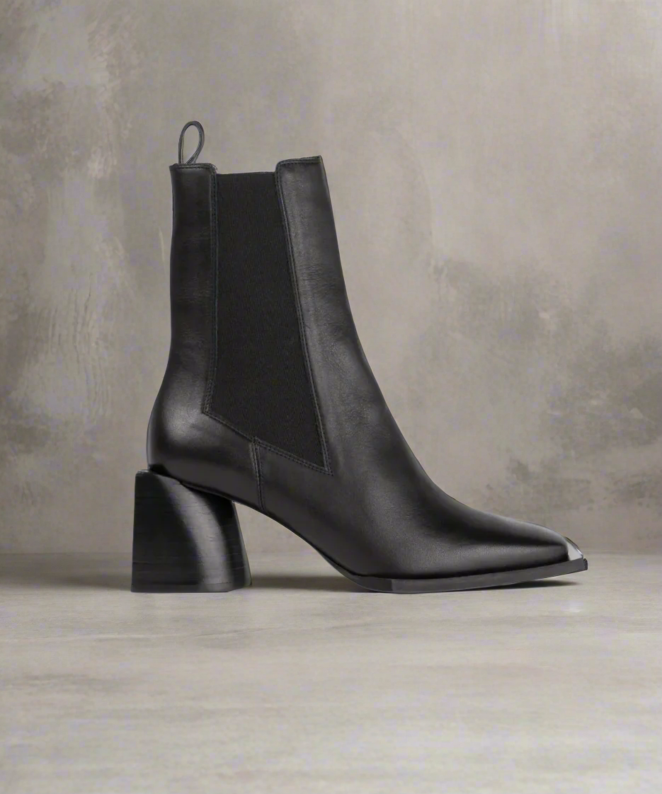 Black Royal RepubliQ ankle boot with a block heel on a gray background