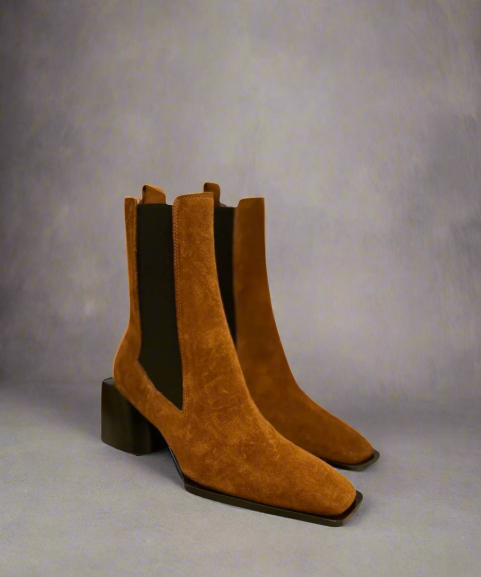 Tan Royal RepubliQ suede boot with a block heel on a light gray background