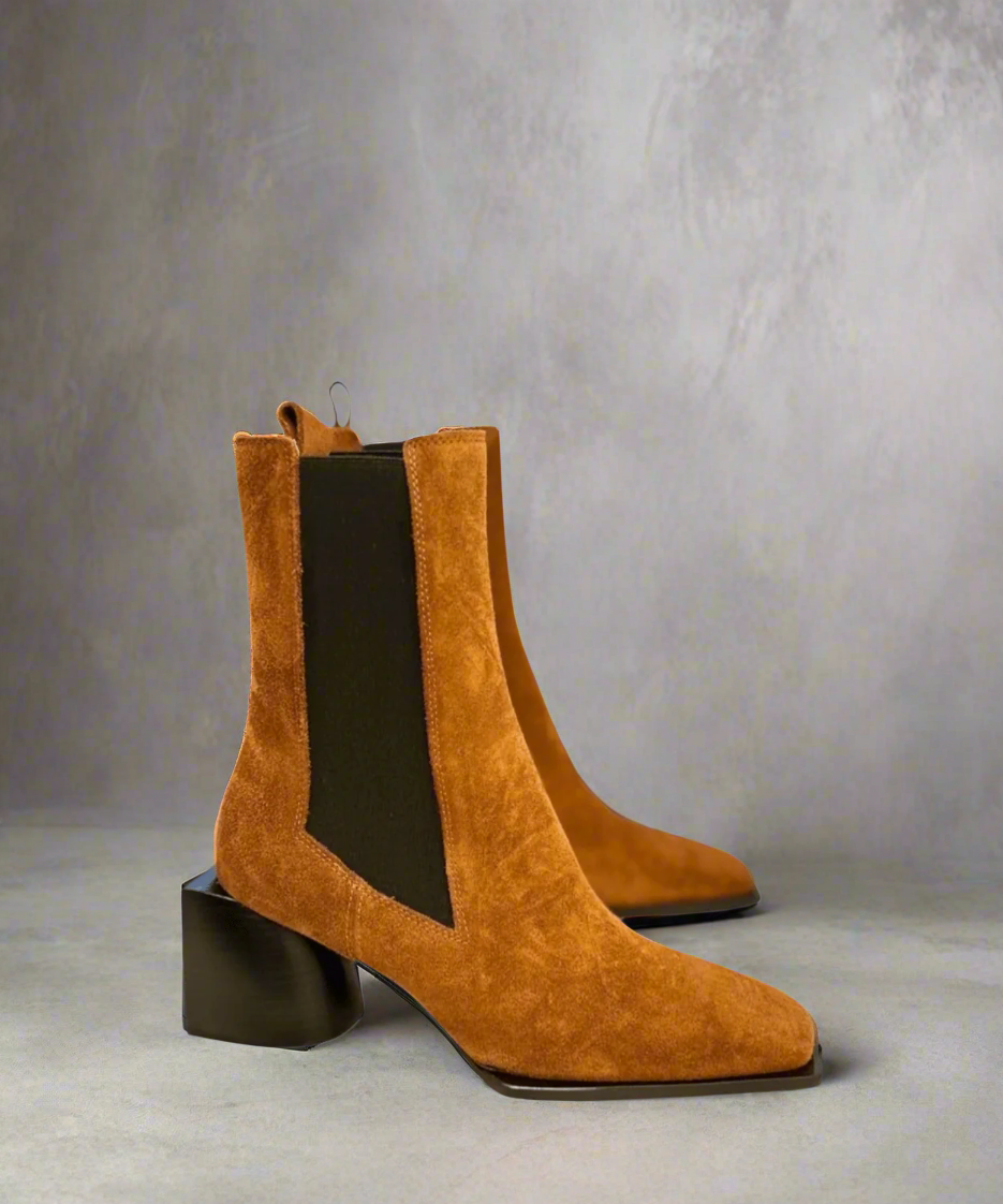 Tan Royal RepubliQ suede boot with a block heel on a light gray background
