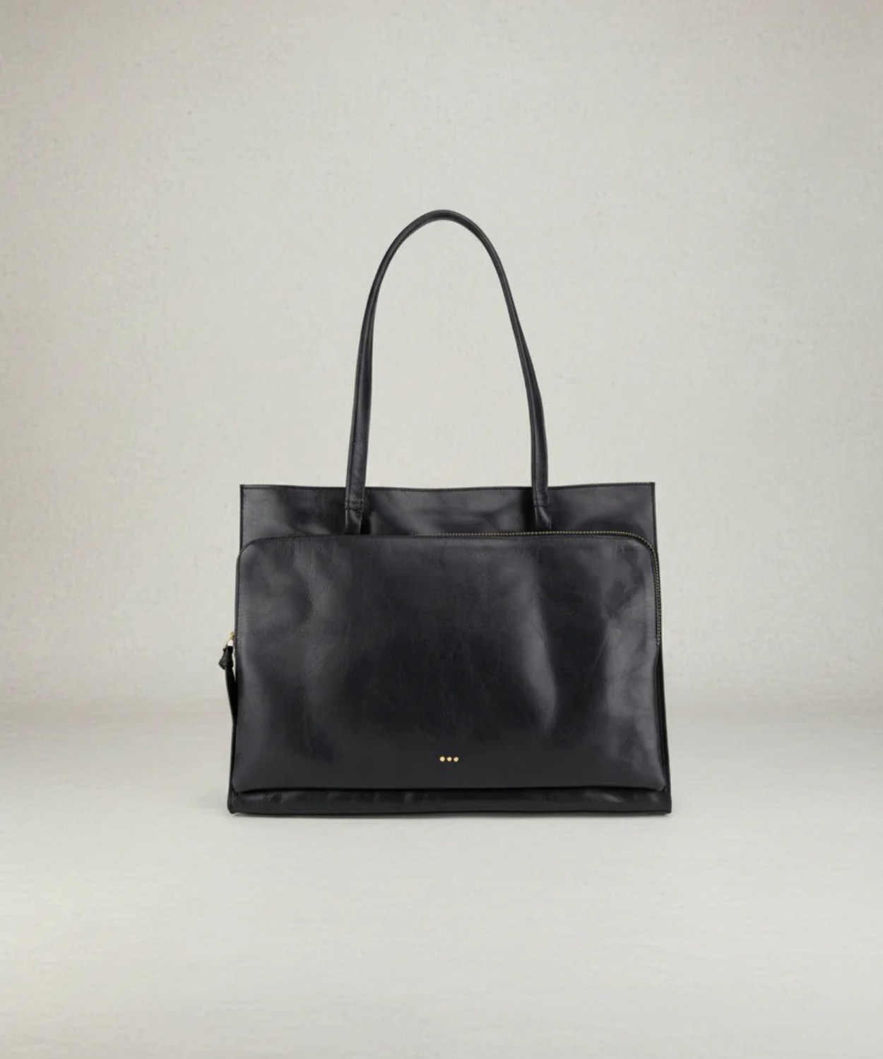 Black handbag on a light gray background