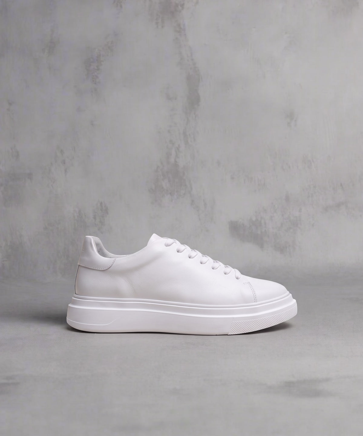 White Royal RepubliQ Vectra One leather sneaker with chunky platform outsole, side profile on a grey concrete background