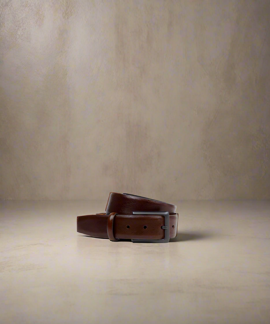 Brown Royal RepubliQ leather belt with matt black metal buckle on a light gray background