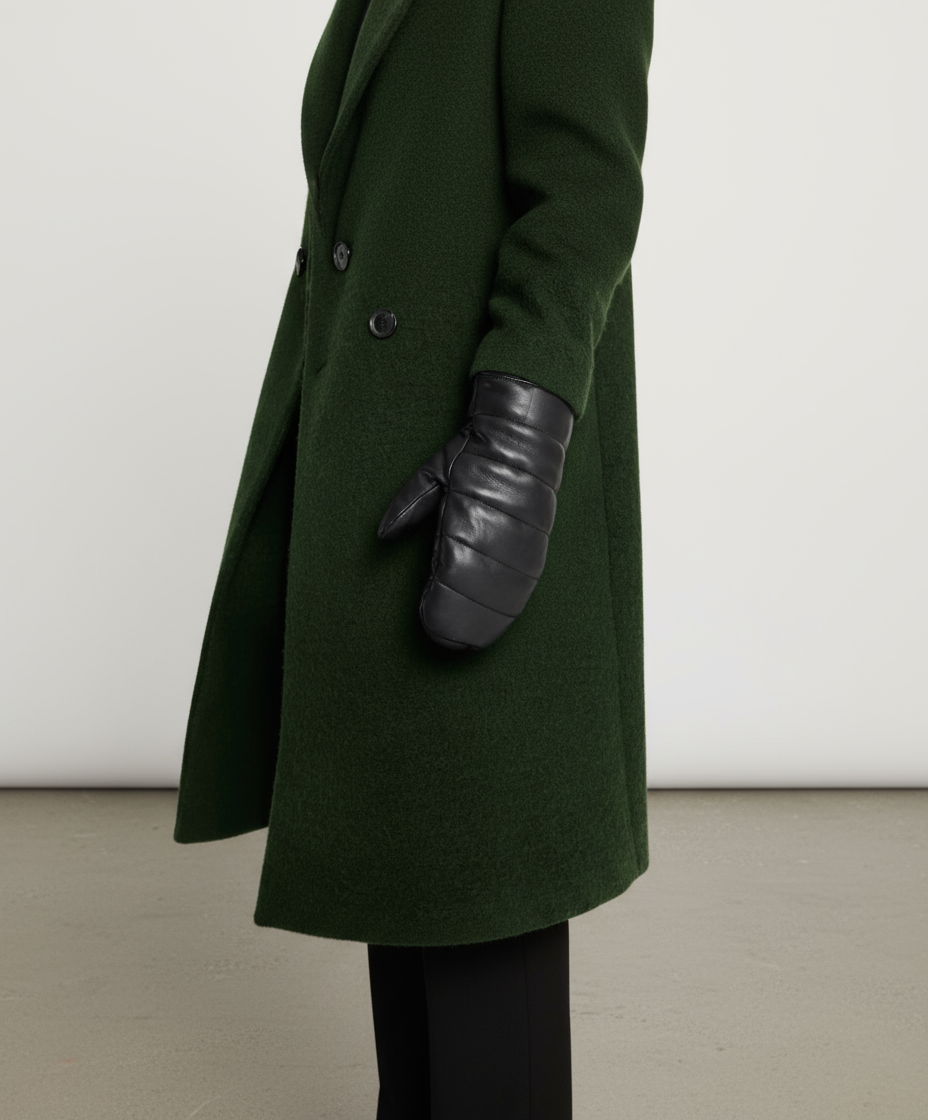 Green coat with a black leather glove on a white background