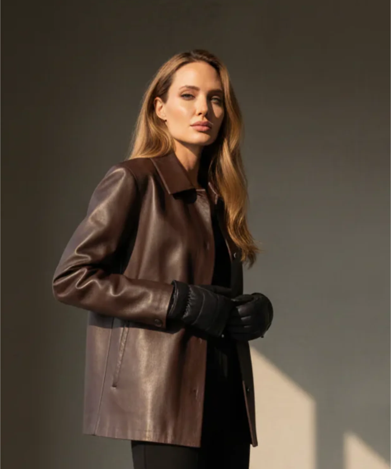 Blond women wearing black Royal RepubliQ padded mittens-gloves in a in a gray roomw