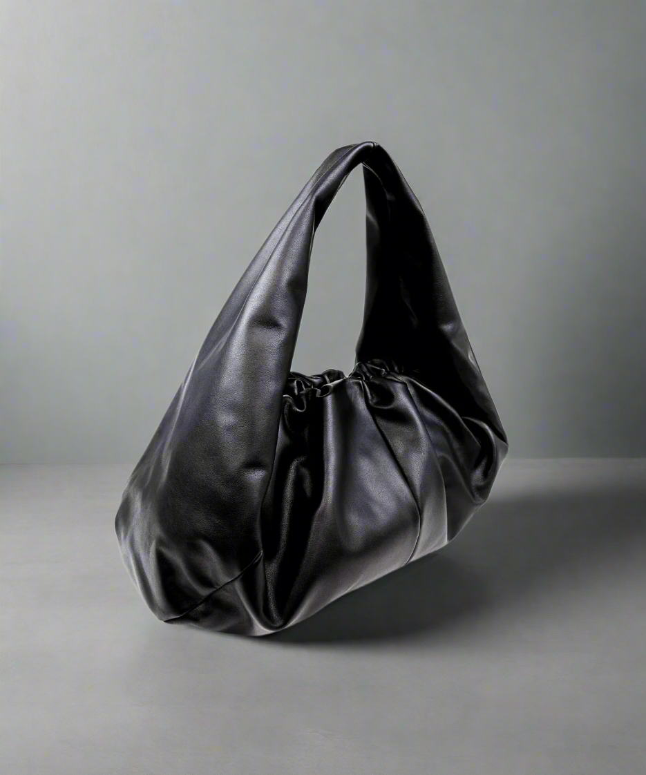 Black Royal RepubliQ leather oversized Pouch handbag on a gray background