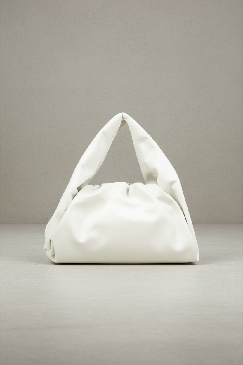 White handbag with a triangular shape on a gray background