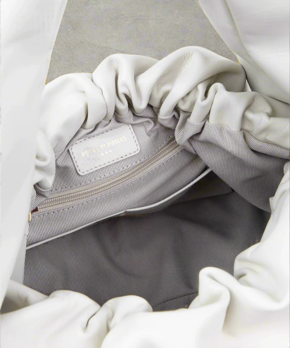 White bag with a visible brand label inside a white garment