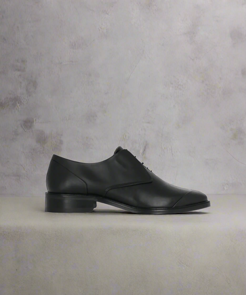 Royal RepubliQ Black leather shoe on a light gray background