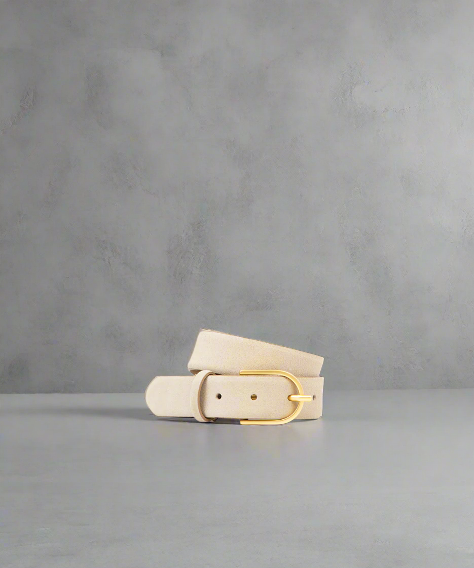 Beige Royal RepubliQ belt with gold buckle on a gray background