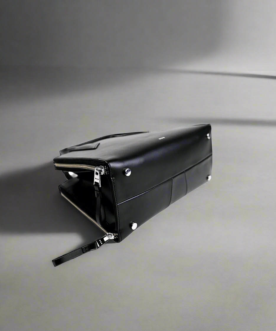 Black leather clutch bag on a white background