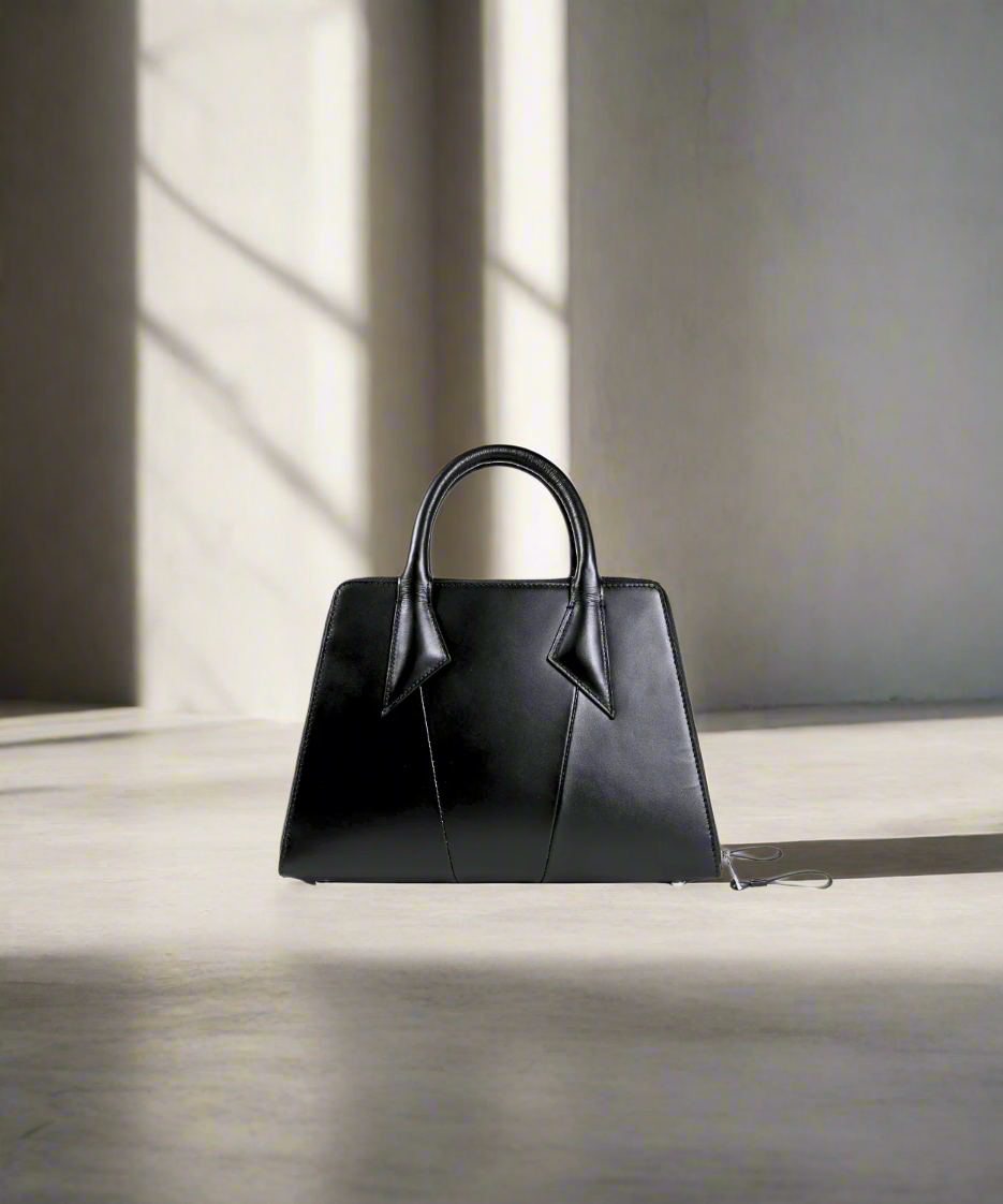 Black handbag on a white background