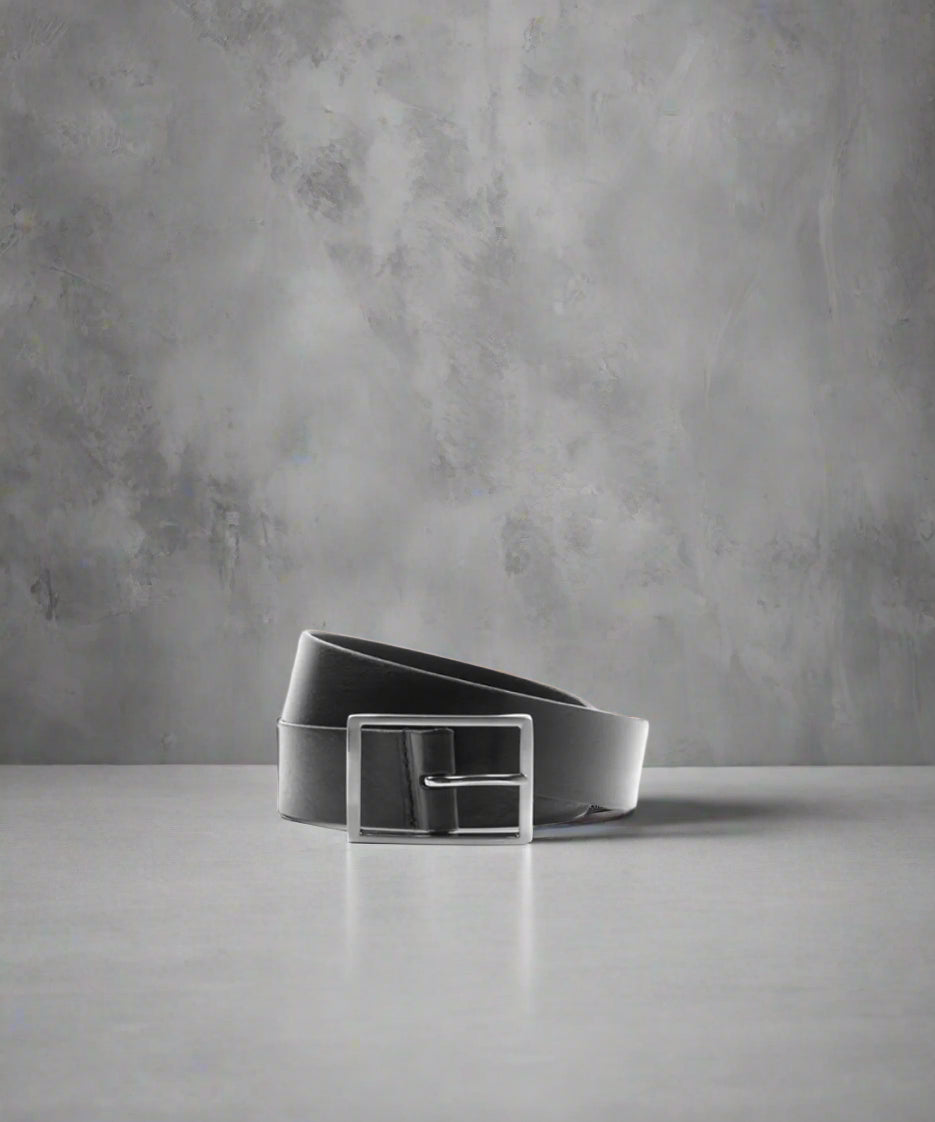 Black Royal RepubliQ belt on a gray surface with a gray background