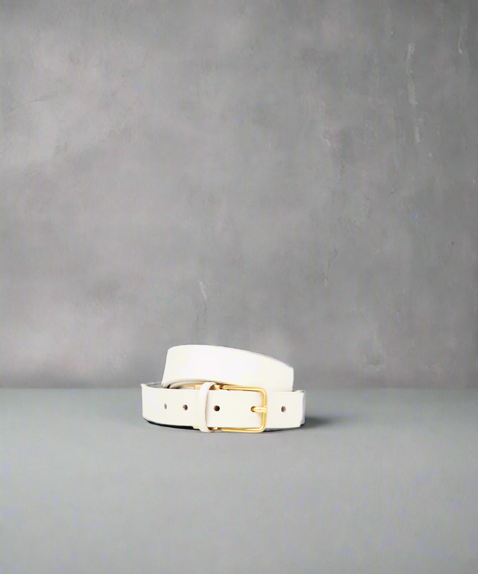 An off white, genuine cow leather belt with a matte gold buckle.