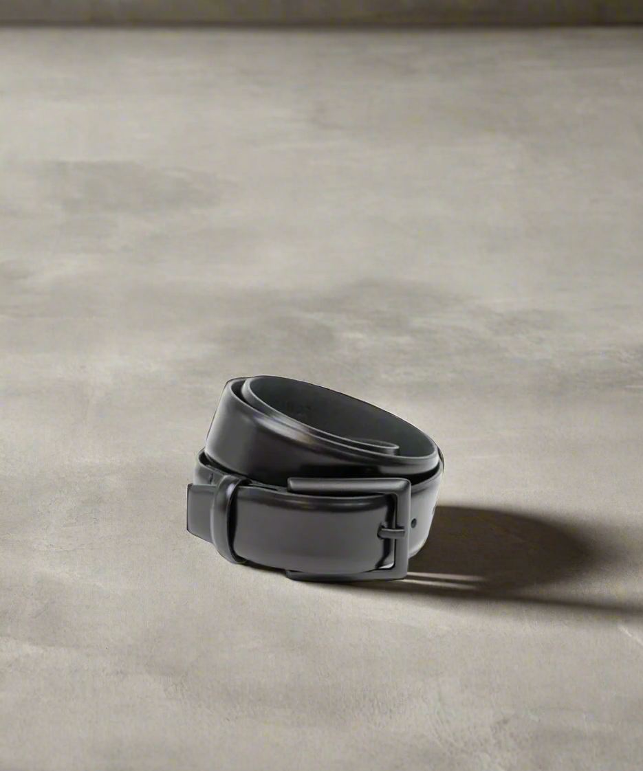 Black Royal RepubliQ belt on a gray concrete surface