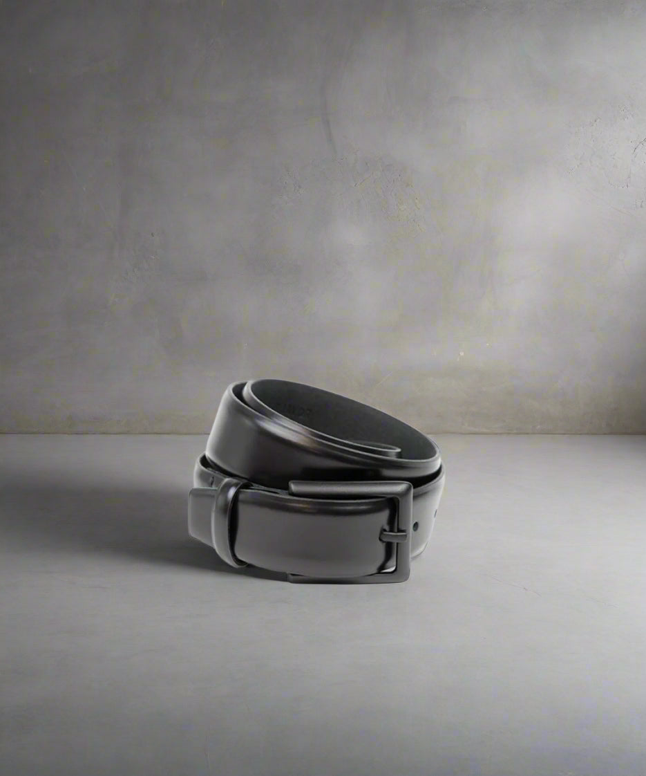 Black leather belt on a light gray background