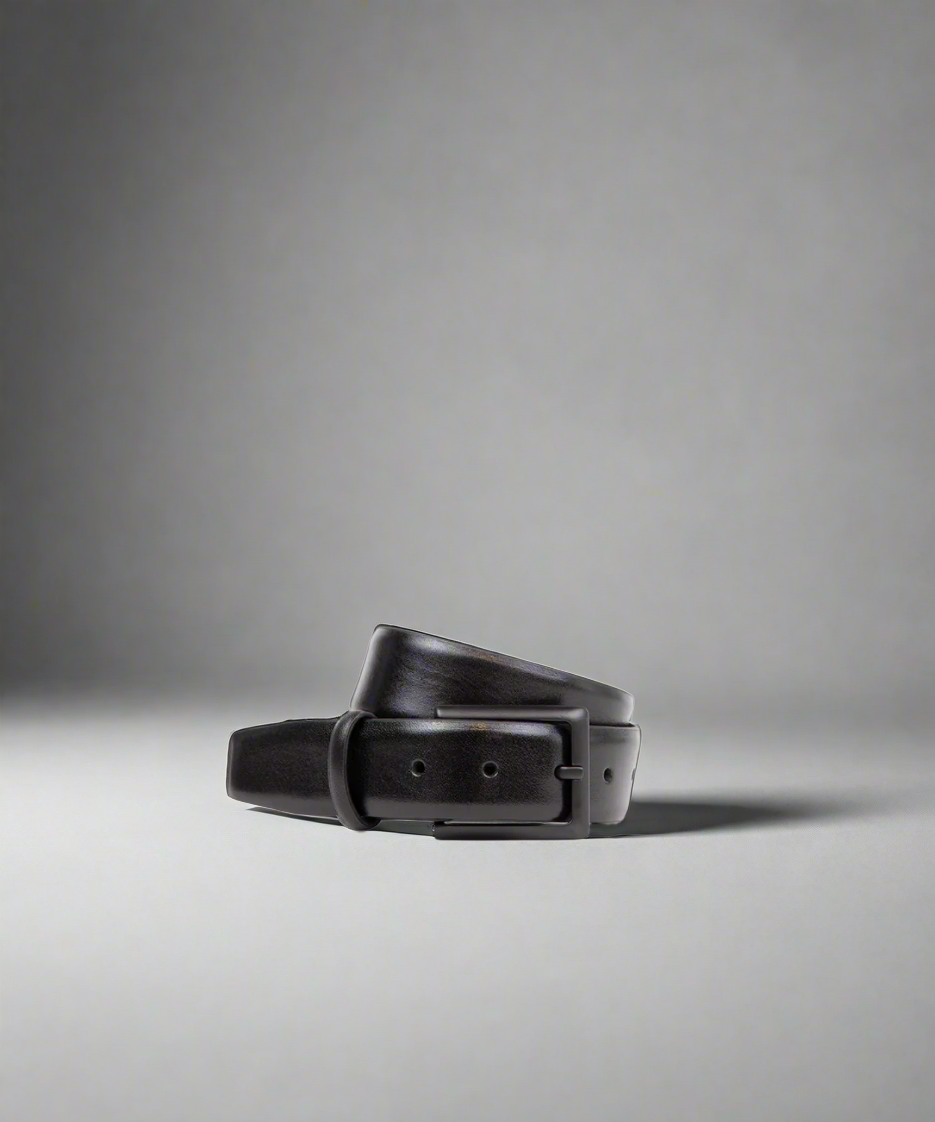 Black leather belt on a gray background