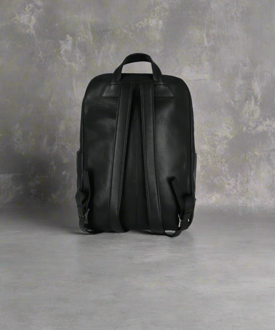 Black leather backpack on a Gray background