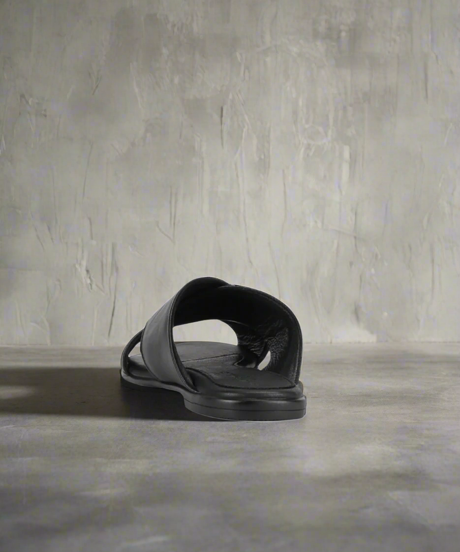 Black sandal on a grey background