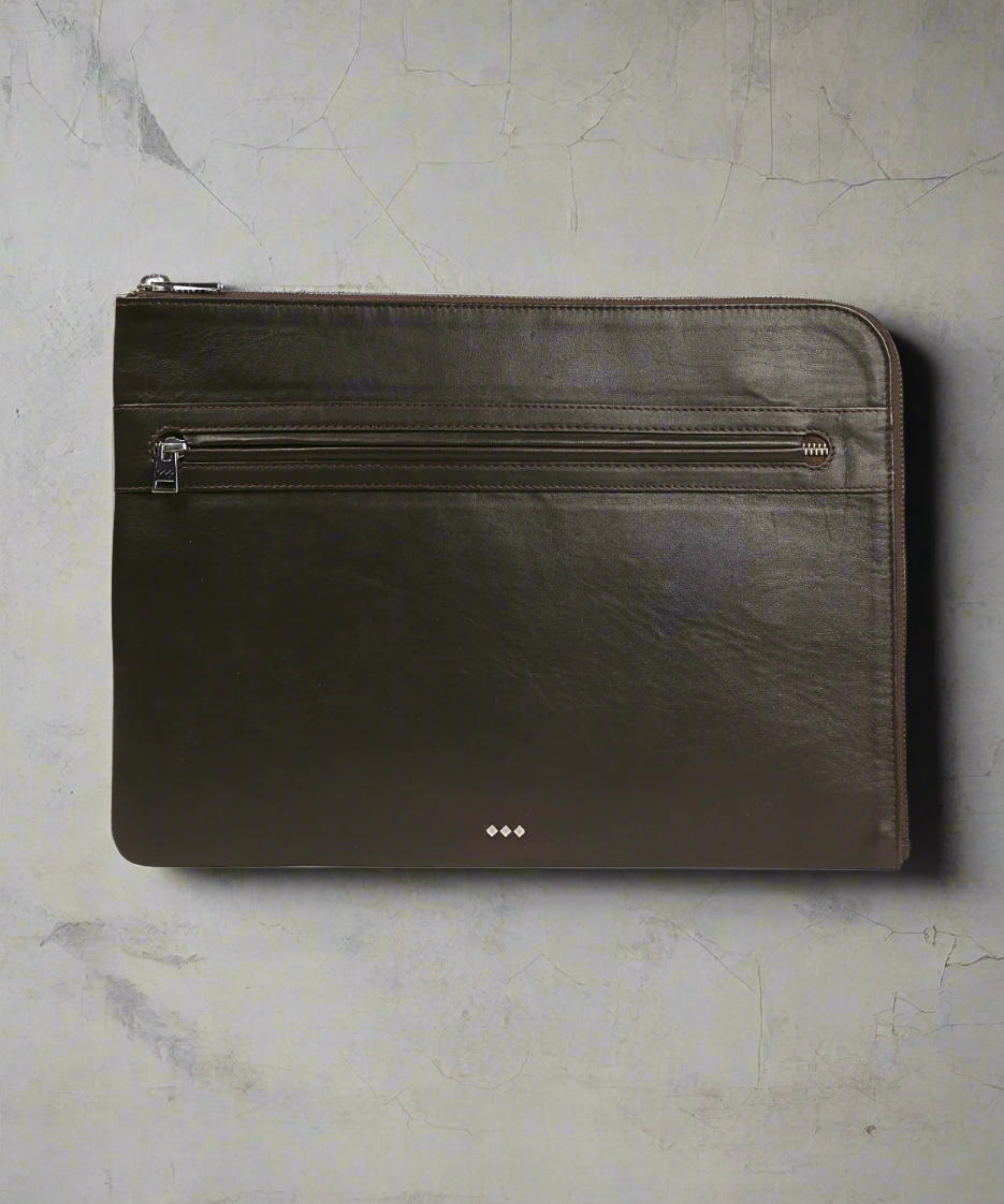 Black leather pouch with zipper on a gray background