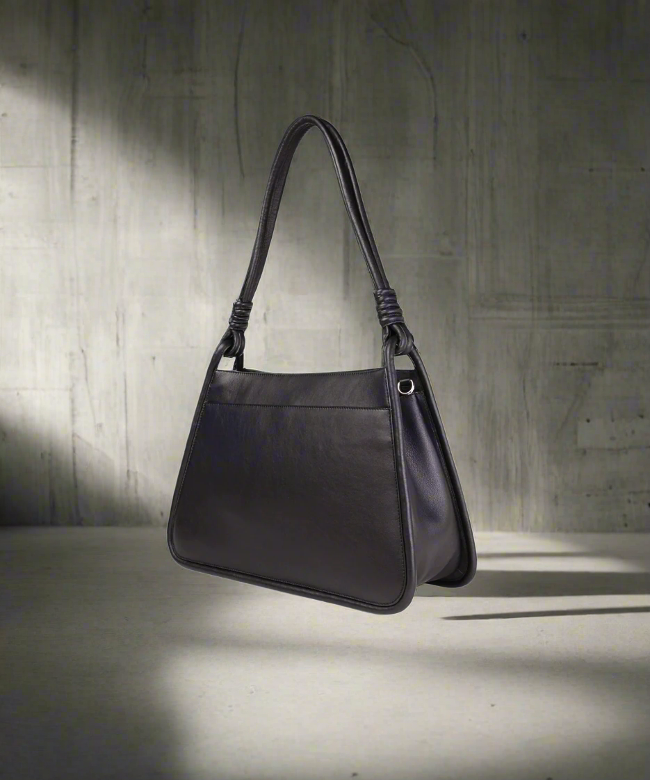 Black handbag on a gray background